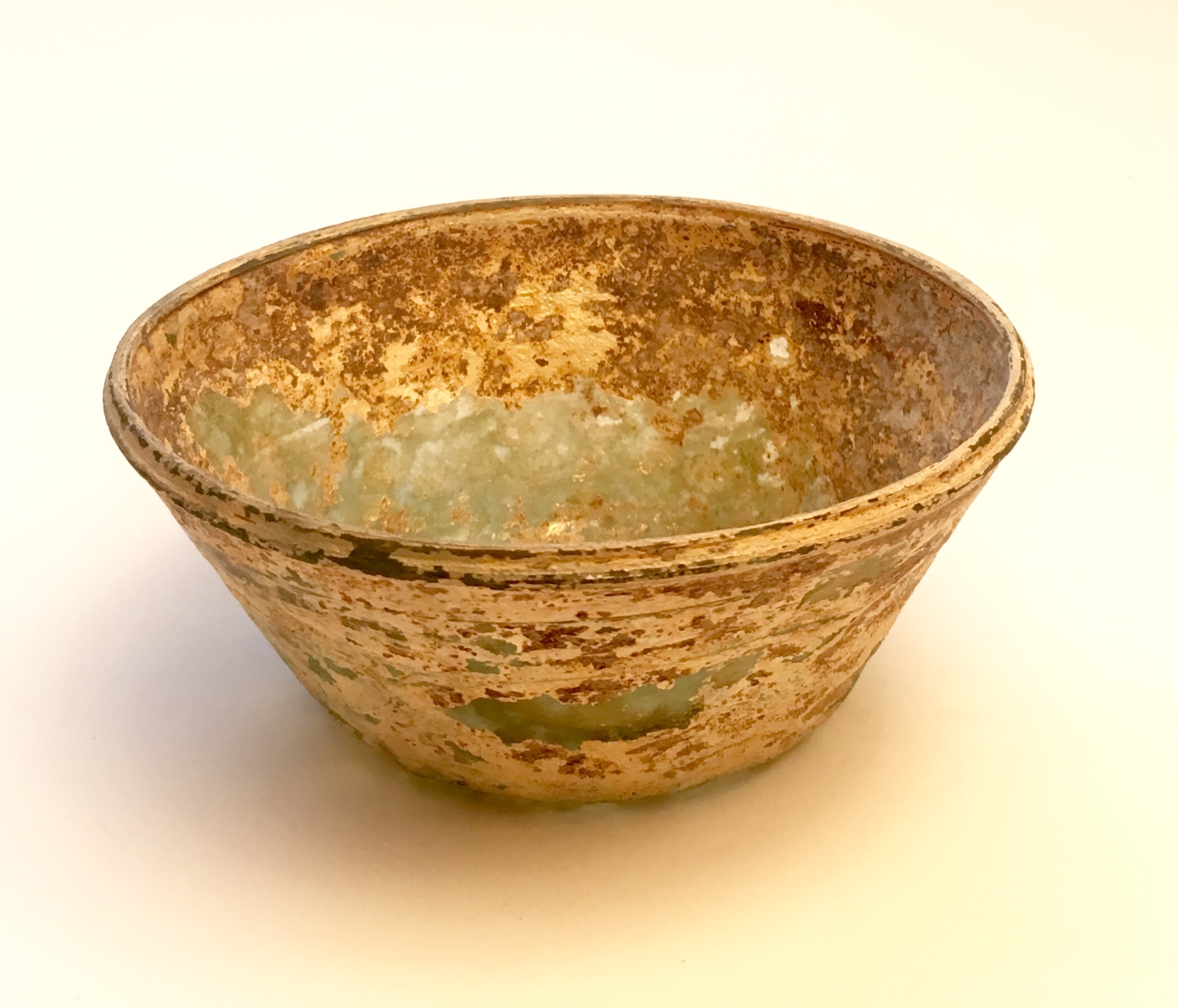 A GREENISH GLASS CONICAL BOWL