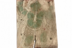 A rectangular ivory plaque with a helmeted musician blowing a conch