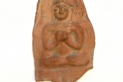 Kashmirian terracotta fragment with seated Buddha with hands in dharmachakra mudra.